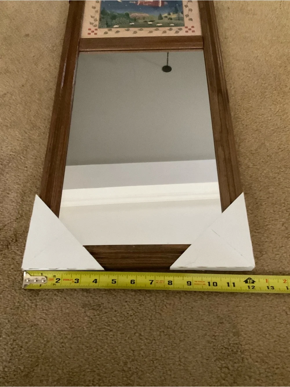 Vintage wood-framed trumeau mirror with a folk art print
